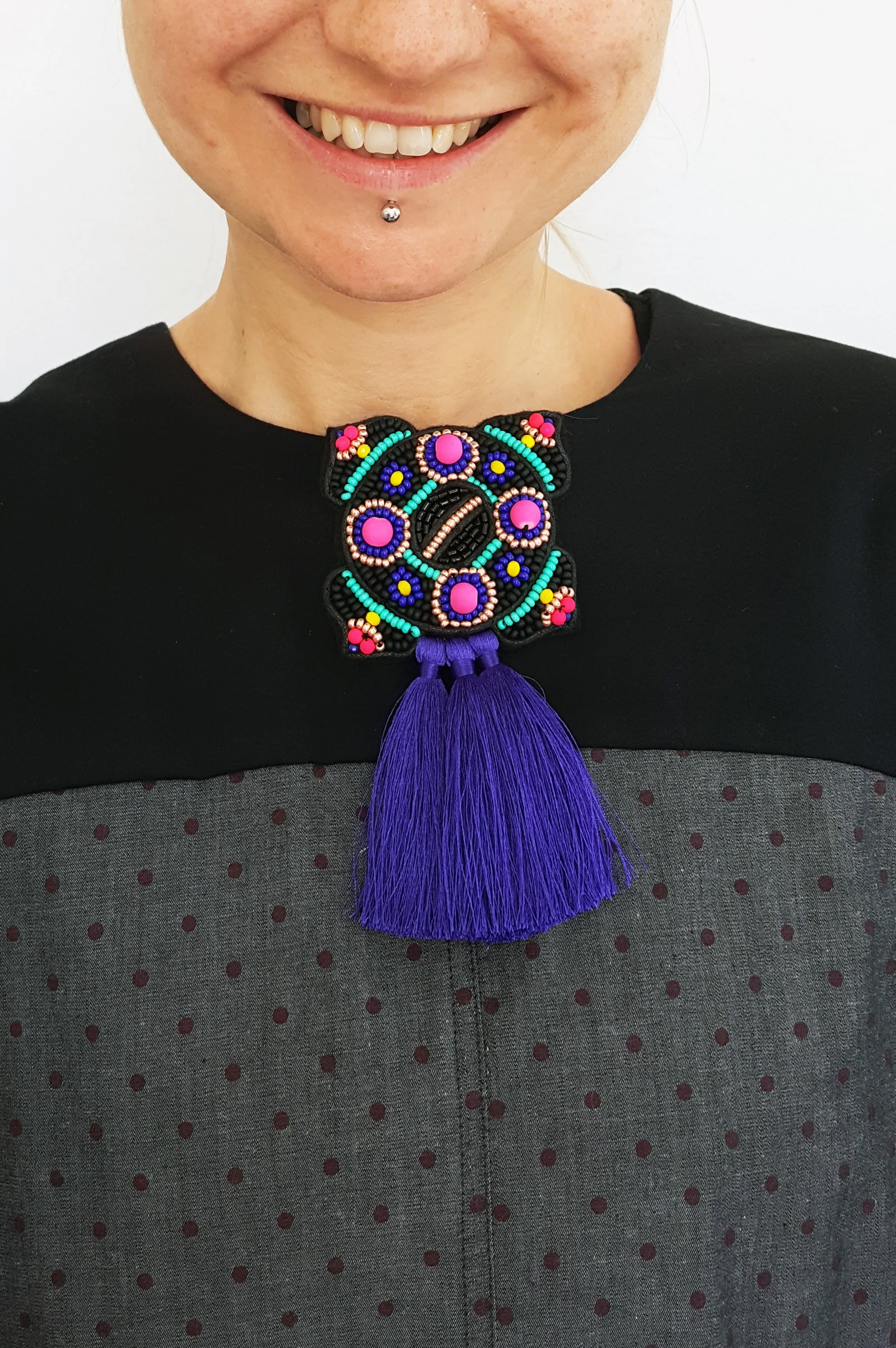 Bright and colorful Ancient brooch with tassels